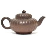 A late 19th/early 20th century Yixing teapot of kabocha shape, unmarked, height 9.5cm.