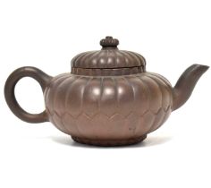 A late 19th/early 20th century Yixing teapot of kabocha shape, unmarked, height 9.5cm.