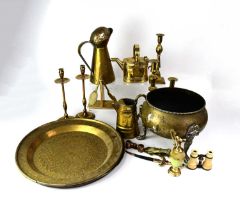 A quantity of brassware to include fire irons, dogs, trays, jugs, candlesticks, kettles, a bell,