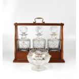 EVERTON FOOTBALL CLUB; a modern wooden tantalus containing three cut glass decanters, with