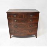 A George III bow-fronted mahogany chest of two short over three long drawers, on outswept bracket