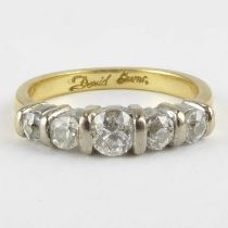 An 18ct five-stone diamond ring, the five graduated tension set brilliant cut diamonds in white