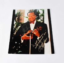 LOUIS FARRAKHAN; a colour photograph signed by religious leader, 25 x 20cm. Condition Report: - We