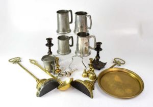 A small quantity of metalware to include five pewter tankards, two weighted brass doorstops, a small