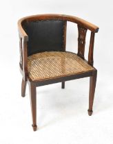 An Edwardian walnut satinwood line inlaid bergère tub chair, with studded leatherette back panel,