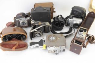 A collection of various vintage cameras, binoculars and cine cameras, to include an Agfa Movex 88L
