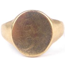 A 9ct gold signet ring, the oval table with crude initials 'C' over 'M', size V, approx. 7.9g.