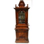 A Victorian walnut cased freestanding penny-in-the-slot polyphon music cabinet, with arched pediment