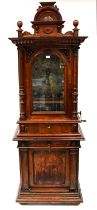 A Victorian walnut cased freestanding penny-in-the-slot polyphon music cabinet, with arched pediment