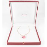 BACCARAT; a gold-plated silver necklace with pink claw set cabochon pendant, in presentation case.