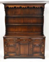 GOSTIN; a Georgian-style oak dresser with enclosed plate rack above a base of three drawers, above