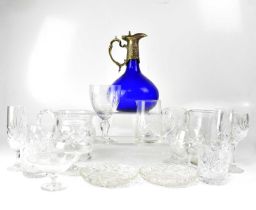 A quantity of glassware to include a blue glass metal mounted claret jug, drinking glasses jugs