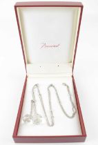 BACCARAT; a silver choke knot adjustable necklace with two clear cut crystal ball drops, in