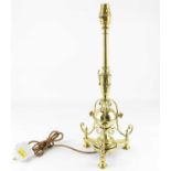 An early 20th century Arts and Crafts cast brass candlestick, height 43cm. Condition Report: Bulb