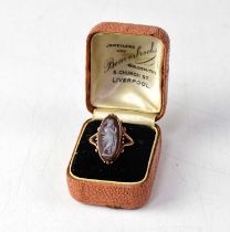 A 9ct rose gold cameo ring, the lozenge-shaped cameo depicting lady in robes, within a scrolling