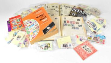 A quantity of loose stamps, mainly British, together with an album containing world stamps and two