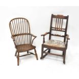 A 19th century ash and elm spindle bow back open arm elbow chair, raised on turned stretchered