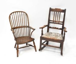 A 19th century ash and elm spindle bow back open arm elbow chair, raised on turned stretchered