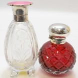 Two cut glass perfume bottles, one Art Deco example with silver cap and rim and pink engine turned