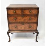 An early 20th century walnut chest of two short of two long graduated drawers, on cabriole base,