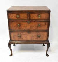 An early 20th century walnut chest of two short of two long graduated drawers, on cabriole base,