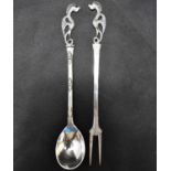 A 20th century Middle Eastern seafood/cocktail fork and spoon set, with dragon finials, marked to