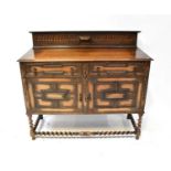 An early 20th century oak sideboard, the raised back with egg and dart decoration, above a base of