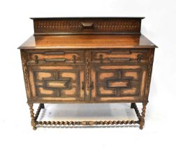 An early 20th century oak sideboard, the raised back with egg and dart decoration, above a base of