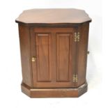 A contemporary oak freestanding cabinet, with shaped top above four panelled doors, raised on plinth