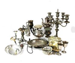 A large quantity of silver plated ware including a five-branch candelabrum, an epergne, tureens,