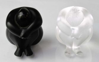LALIQUE; a pair of seated figures, titled 'Statuette Nu Nabhi' and 'Stauette Nu Nabhi Noir', both in
