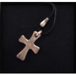 GEORG JENSEN; a sterling silver (925) cross pendant, pattern no.565, on black necklace cord, stamped