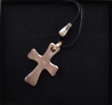 GEORG JENSEN; a sterling silver (925) cross pendant, pattern no.565, on black necklace cord, stamped