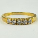 An 18ct gold diamond ring, the top with five small claw set brilliant cut diamonds, total stated