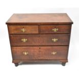 A Georgian oak and mahogany cross-banded chest of two short over two long graduated drawers,