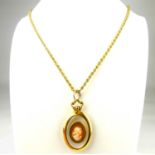 A clear oval necklace pendant in a 9ct gold mount, with a later applied cameo and gold-coloured