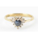 A 9ct gold ring with central heart-shaped sapphire in a heart-shaped border cluster of tiny
