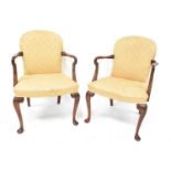 A pair of Georgian-style mahogany open elbow chairs with spoon backs and cabriole legs,