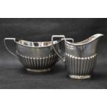 A late Victorian hallmarked silver milk jug, height 7.5cm, and matching sugar bowl, John Millward