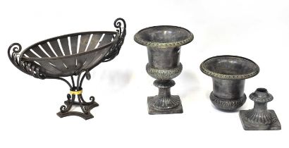 A pair of spelter urns of Classical form, with fluted circular feet, on square bases, height of each