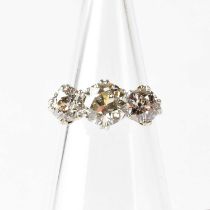 A platinum three-stone diamond ring, the central diamond approx. 2ct, flanked by approx. 1ct