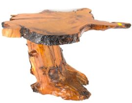 A small high lacquered coffee table of naturalistic form, featuring a tree trunk slice top, height