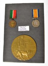 A Remembrance Plaque for 'John Jones', mounted on a board with a WWI Mercantile Marine War Medal and