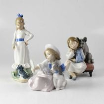 LLADRÓ; two figures of children with dogs, together with a Nao figure of a girl with a dog, height