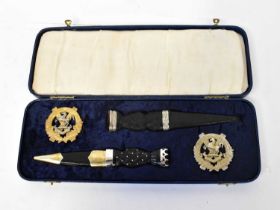 A presentation cased set containing two Scottish dirks and two cap badges for The King's Liverpool