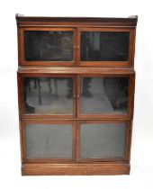 An early 20th century mahogany three-section stacking waterfall bookcase, each with pair of glazed