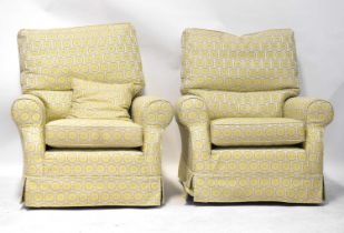 A pair of modern armchairs upholstered in a woven gold, blue and beige repeating pattern cover, both