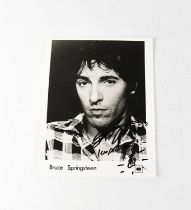 BRUCE SPRINGSTEEN; a black and white CBS Records promotional photograph signed by Bruce Springsteen,