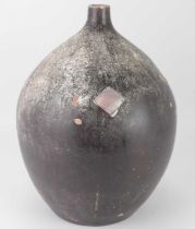 An unusual, possibly African, studio pottery vessel of ovoid form with short narrow neck,