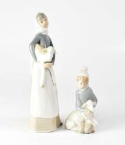 LLADRÓ; two figures of young ladies, each holding a lamb, height of tallest 27.5cm (2). Condition